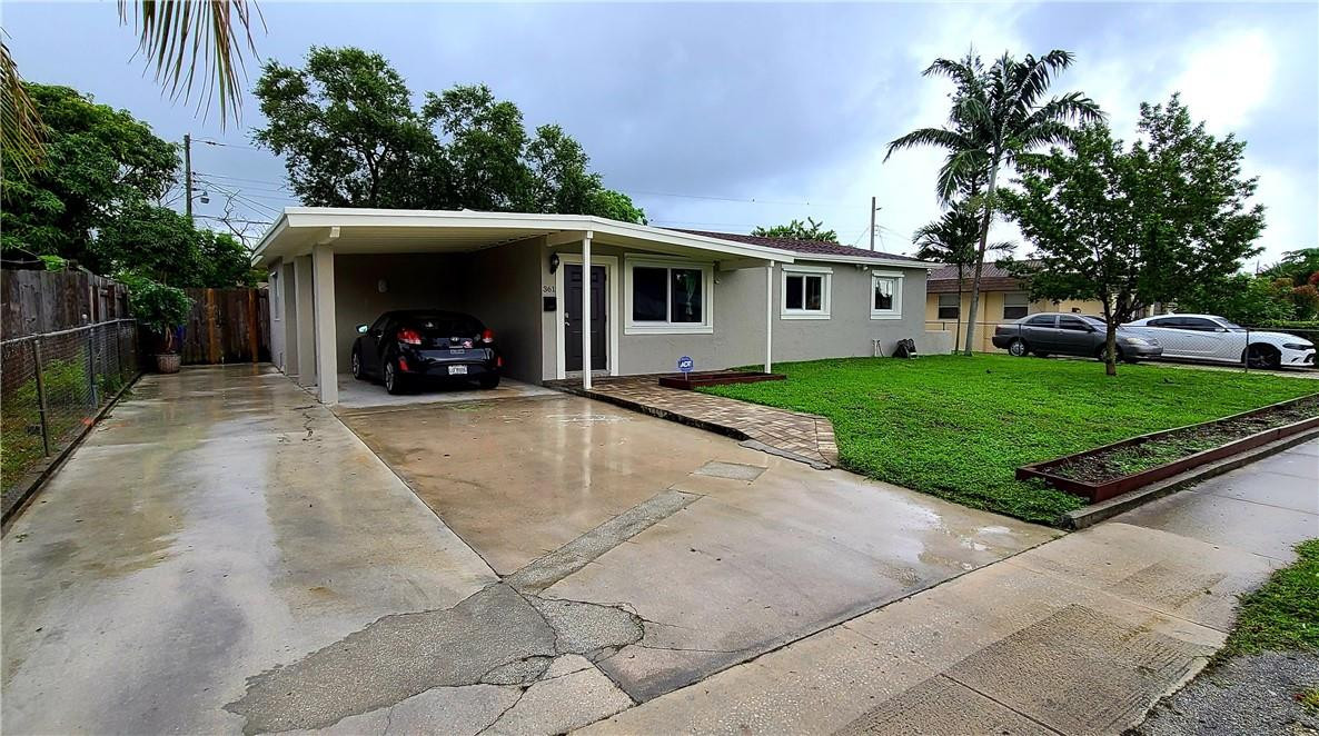 361 Northwest 37th Street Pompano Beach, FL 33064 - Photo 1 of 21 a view of a house with a yard and potted plants