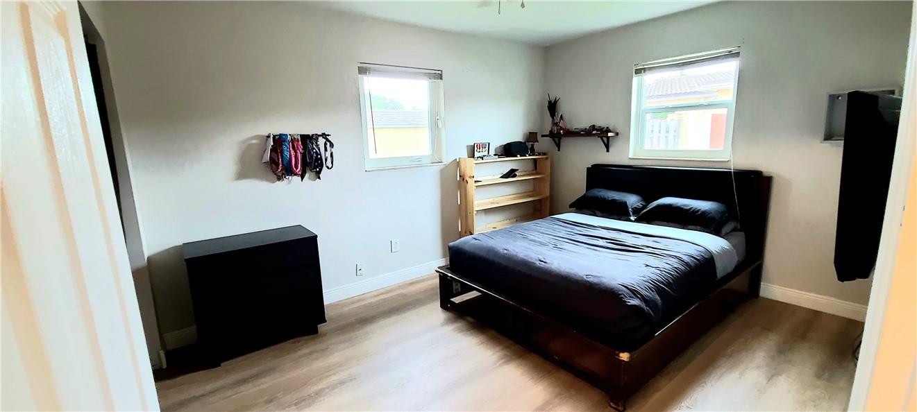 361 Northwest 37th Street Pompano Beach, FL 33064 - Photo 13 of 21 a bedroom with a bed and a window