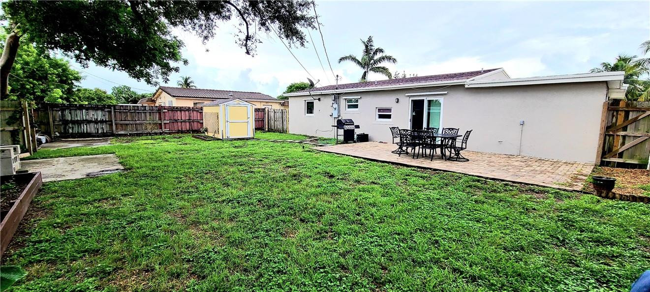 361 Northwest 37th Street Pompano Beach, FL 33064 - Photo 20 of 21 a view of a house with backyard sitting area and garden