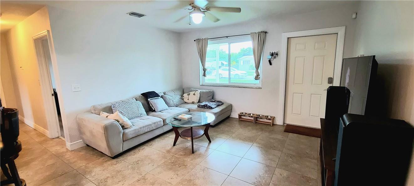 361 Northwest 37th Street Pompano Beach, FL 33064 - Photo 3 of 21 a living room with furniture and a flat screen tv
