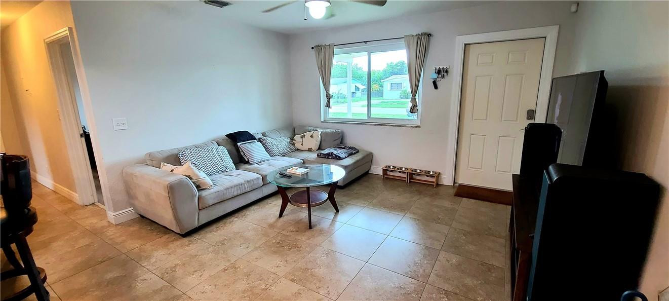361 Northwest 37th Street Pompano Beach, FL 33064 - Photo 4 of 21 a living room with furniture and a flat screen tv