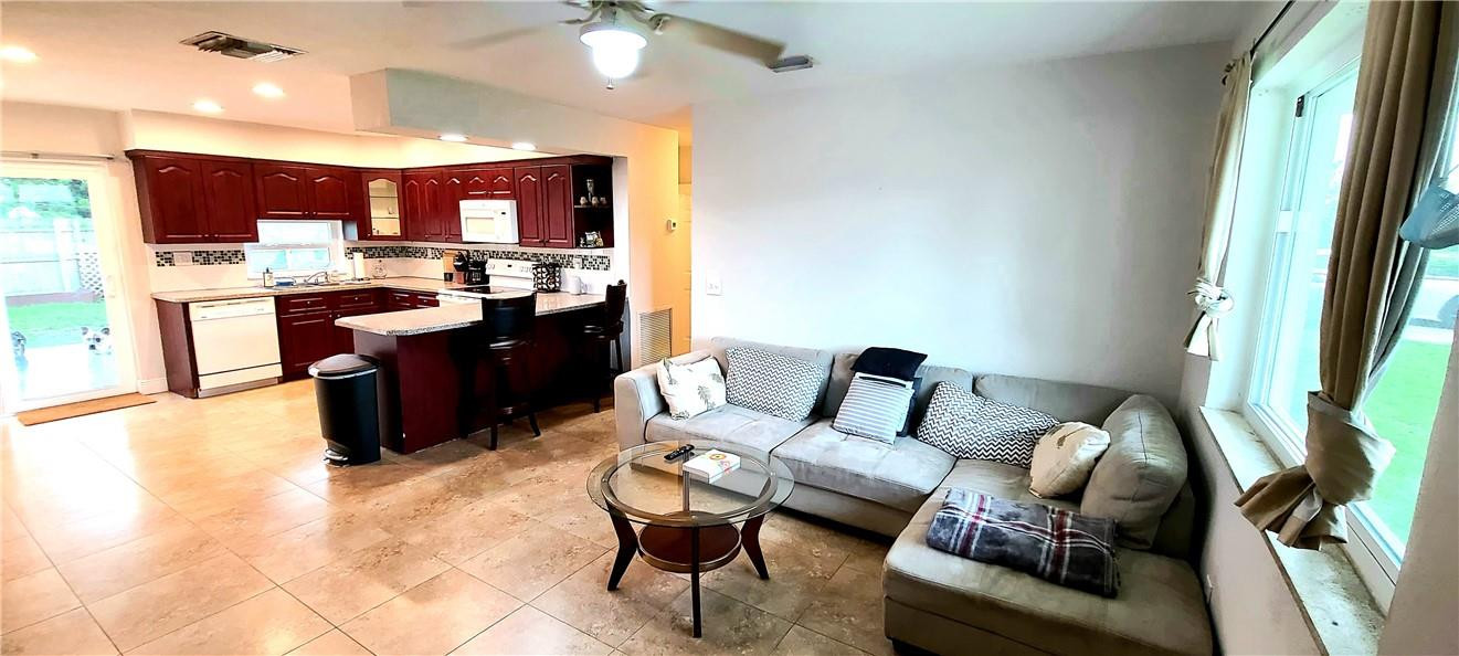 361 Northwest 37th Street Pompano Beach, FL 33064 - Photo 5 of 21 a living room with furniture and a wooden floor