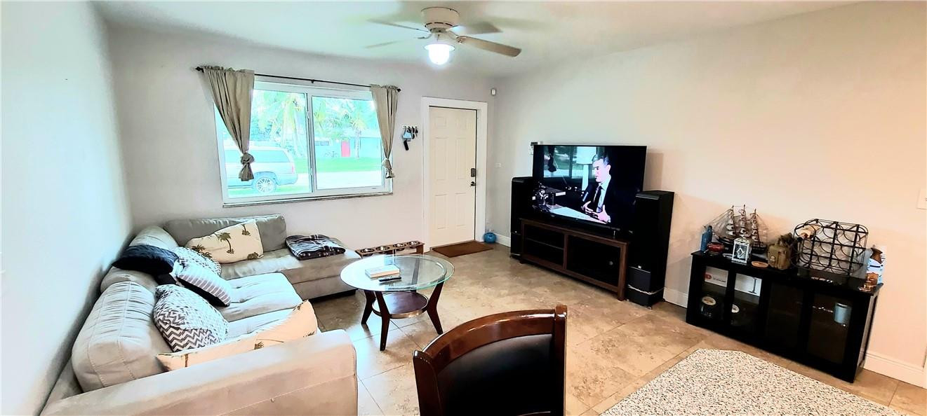 361 Northwest 37th Street Pompano Beach, FL 33064 - Photo 8 of 21 a living room with furniture and a flat screen tv