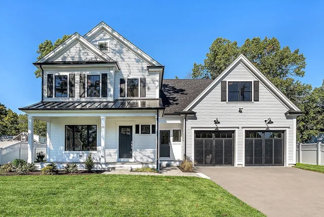 a front view of a house with a yard and porch