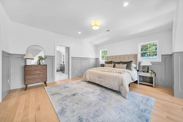 a bedroom with a large bed and a dresser