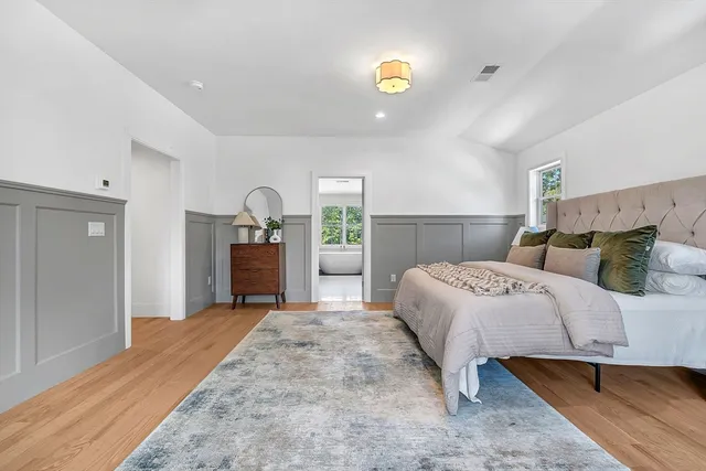 a bed room with a bed and dresser