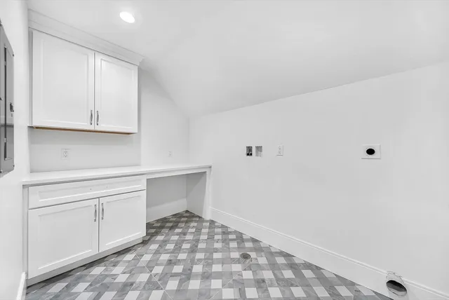 a kitchen with white cabinets and a sink