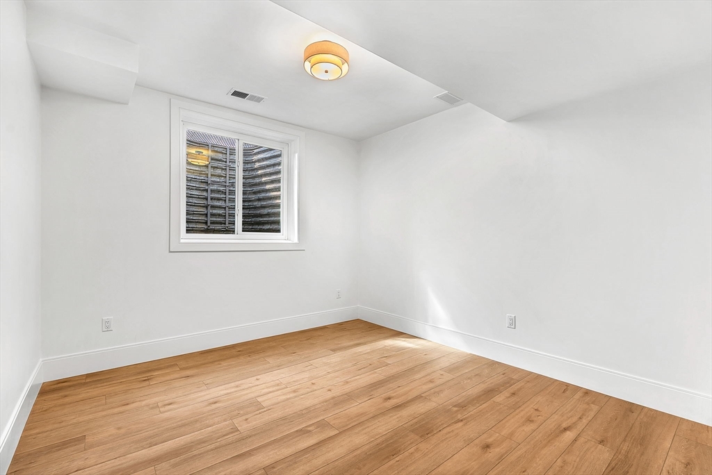 25 Euclid Avenue Natick, MA 01760 - Photo 34 of 41 an empty room with wooden floor and windows