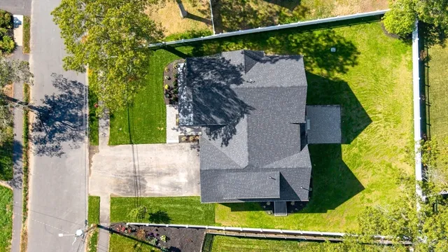 a view of house with a yard