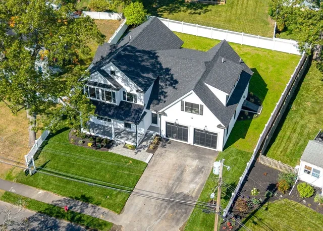 an aerial view of a house with a garden and swimming pool