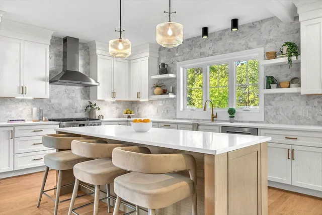 a kitchen with cabinets a center island and appliances