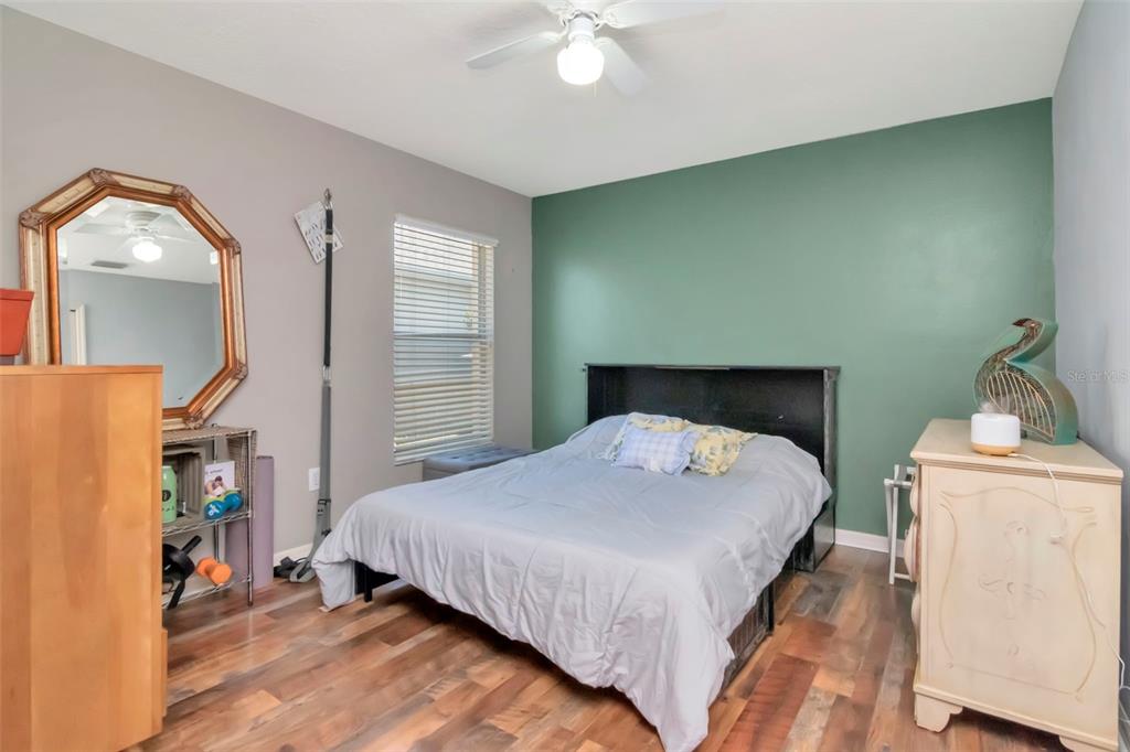 19103 Wind Dancer Street Lutz, FL 33558 - Photo 25 of 41 a bedroom with a bed a mirror and cabinets