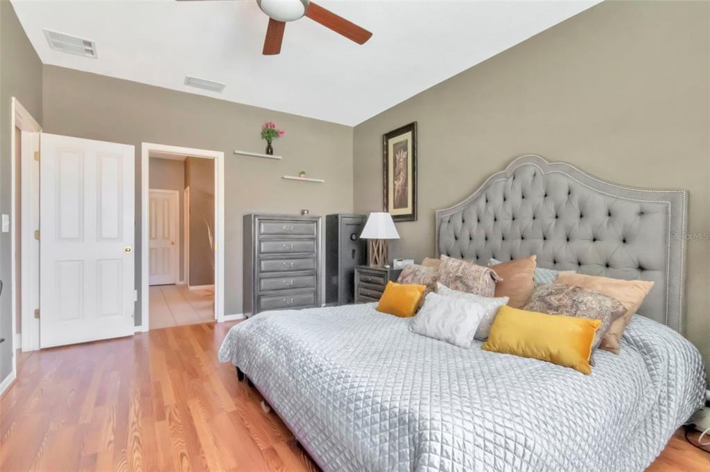 19103 Wind Dancer Street Lutz, FL 33558 - Photo 27 of 41 a bedroom with a bed and wooden floor