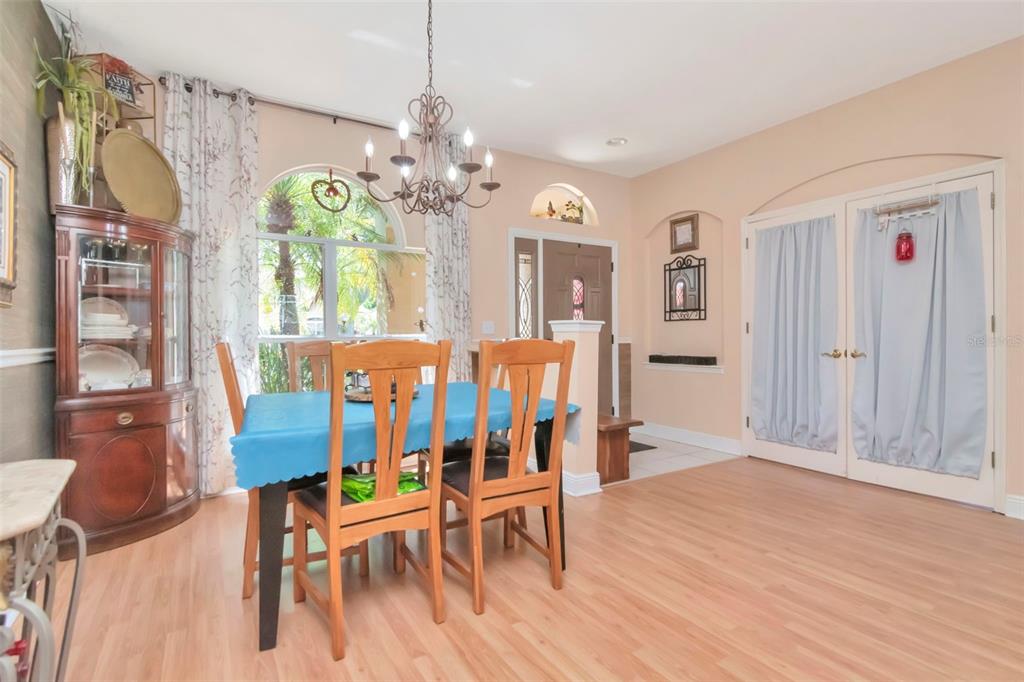 19103 Wind Dancer Street Lutz, FL 33558 - Photo 5 of 41 a view of a dining room with furniture a chandelier and wooden floor