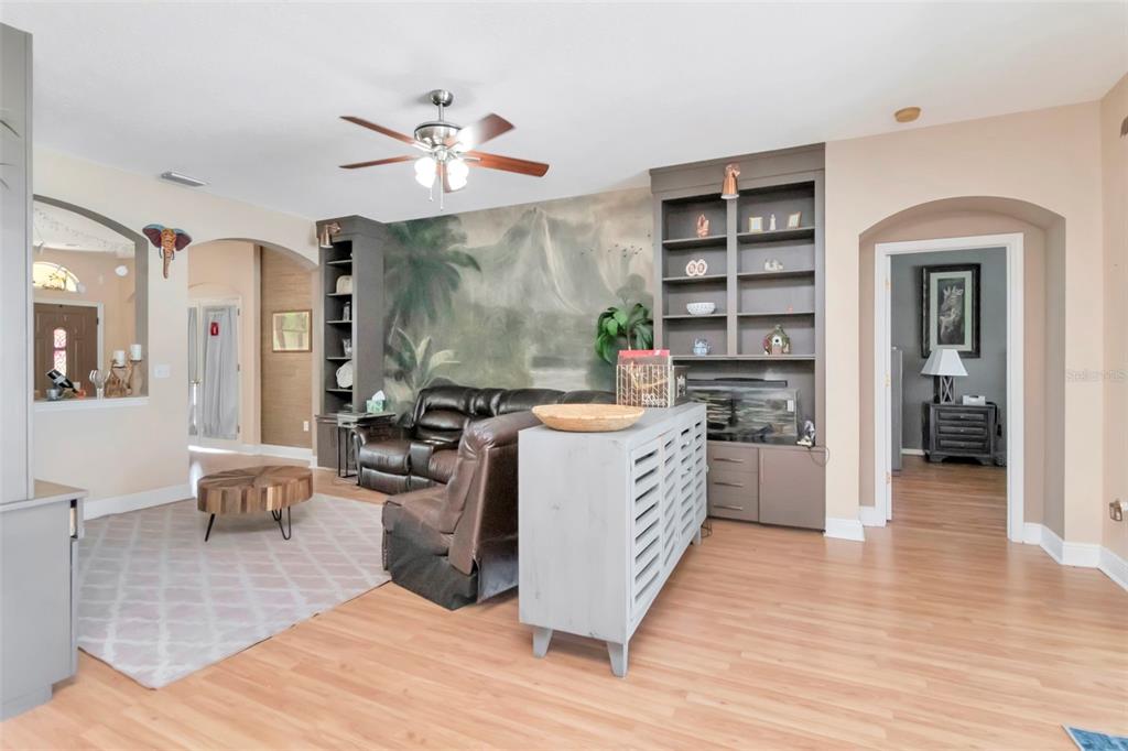 19103 Wind Dancer Street Lutz, FL 33558 - Photo 10 of 41 a kitchen with stainless steel appliances kitchen island granite countertop a stove top oven a sink a dining table and chairs with wooden floor