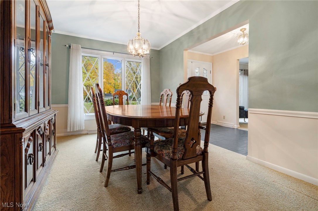 14265 Reeder Avenue Northeast Alliance, OH 44601 - Photo 7 of 39 Dining space with light colored carpet, ornamental molding, and a chandelier