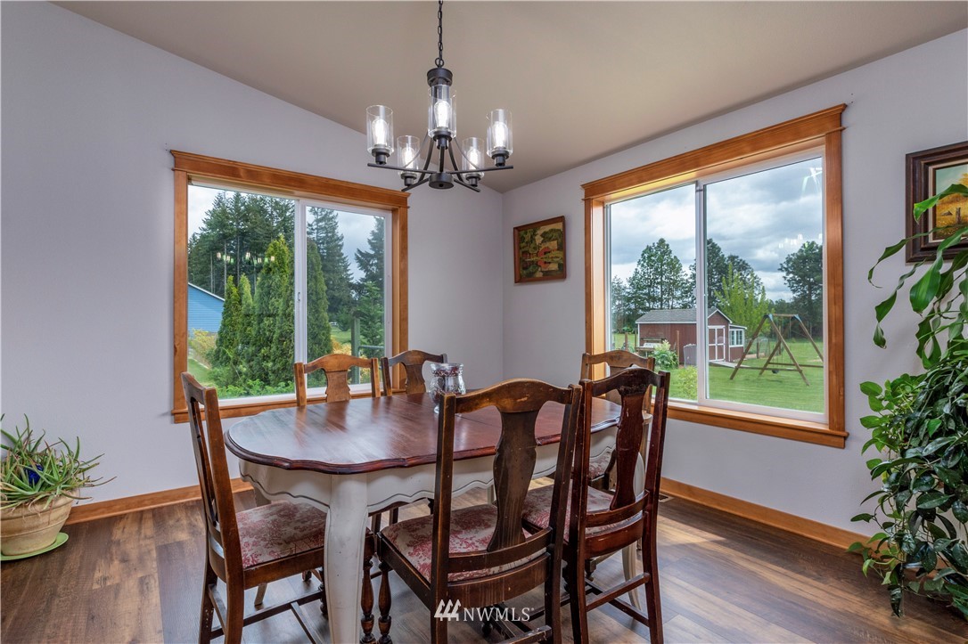 6519 190th Trail Southwest Rochester, WA 98579 - Photo 11 of 40 a dining room with furniture window wooden floor