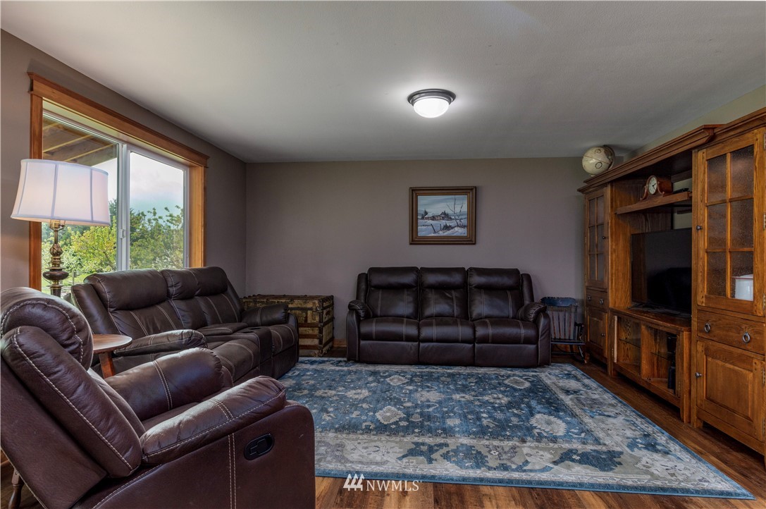 6519 190th Trail Southwest Rochester, WA 98579 - Photo 16 of 40 a living room with furniture and a flat screen tv