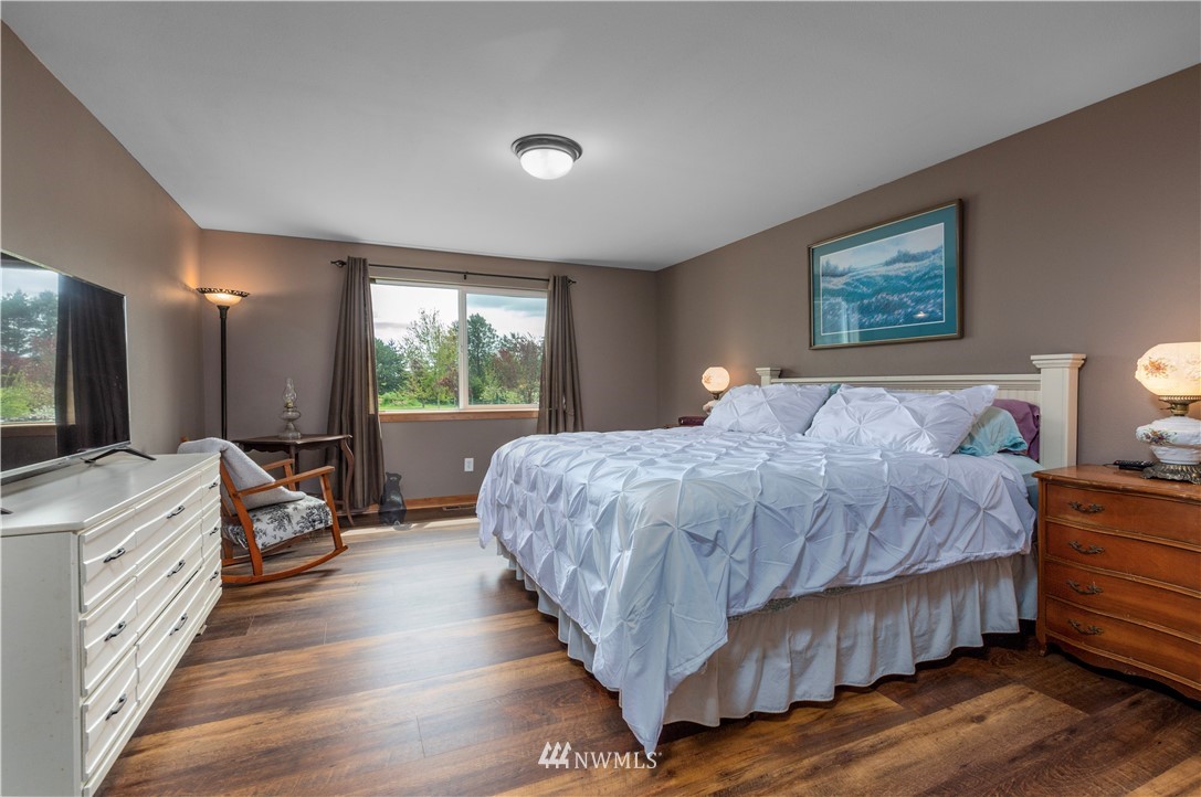 6519 190th Trail Southwest Rochester, WA 98579 - Photo 20 of 40 a bed room with a bed and a television