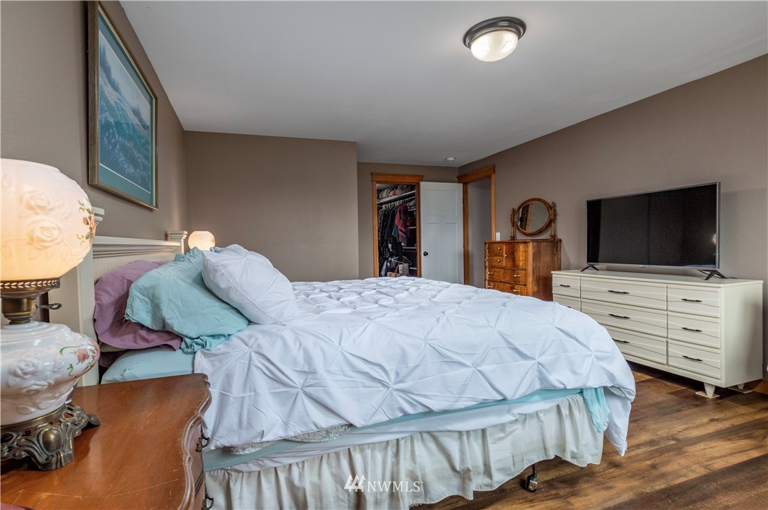 6519 190th Trail Southwest Rochester, WA 98579 - Photo 21 of 40 a bedroom with a bed and flat screen tv