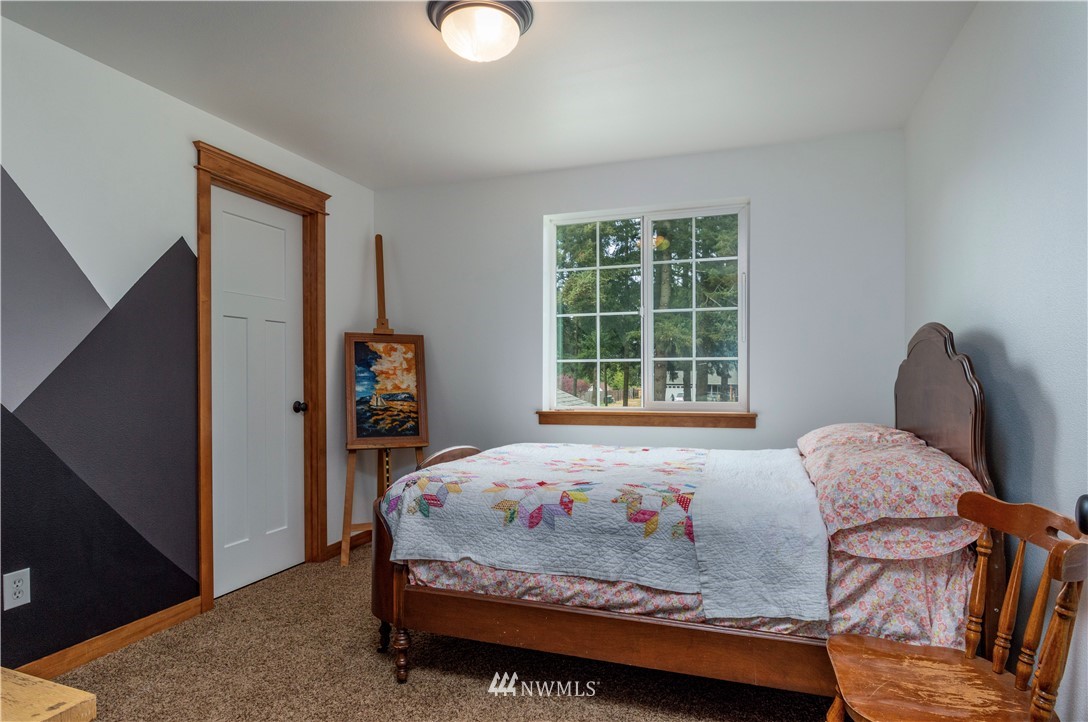 6519 190th Trail Southwest Rochester, WA 98579 - Photo 24 of 40 a bedroom with a bed and wooden floor