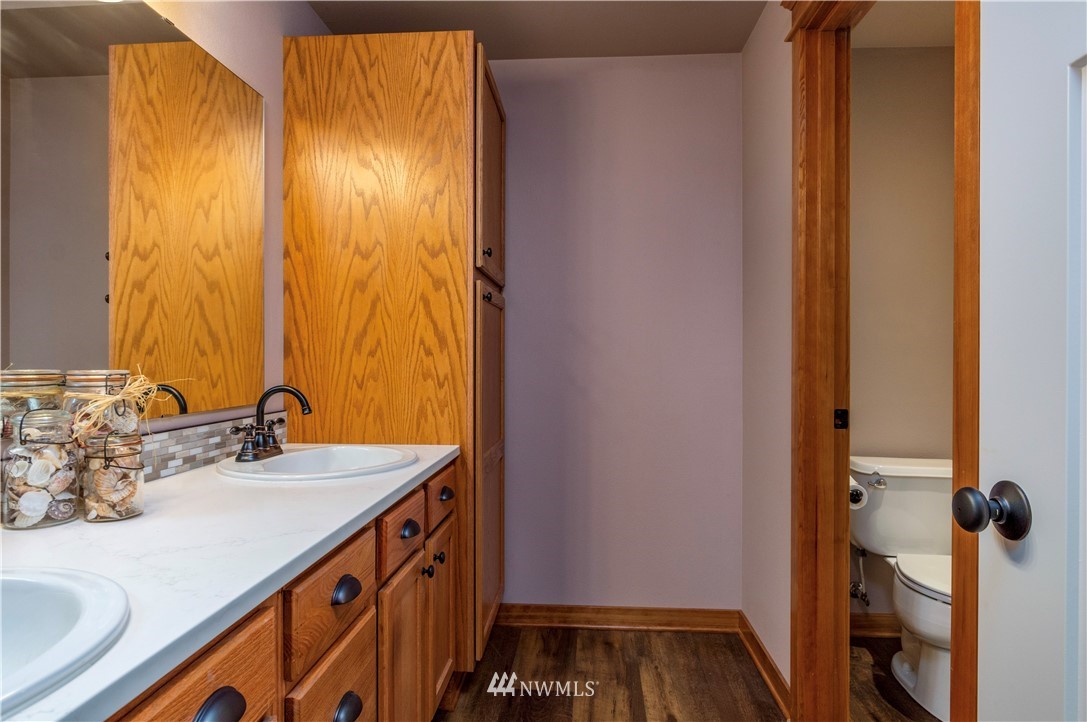 6519 190th Trail Southwest Rochester, WA 98579 - Photo 25 of 40 a bathroom with a sink and a mirror