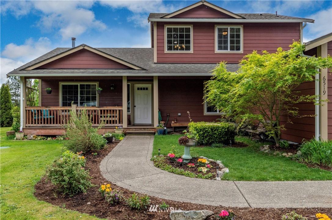 6519 190th Trail Southwest Rochester, WA 98579 - Photo 4 of 40 a front view of a house with a garden