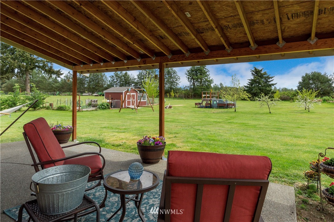 6519 190th Trail Southwest Rochester, WA 98579 - Photo 32 of 40 a patio with garden area and furniture