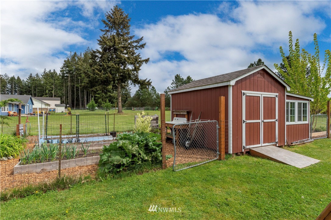 6519 190th Trail Southwest Rochester, WA 98579 - Photo 34 of 40 a view of a house with backyard porch and garden