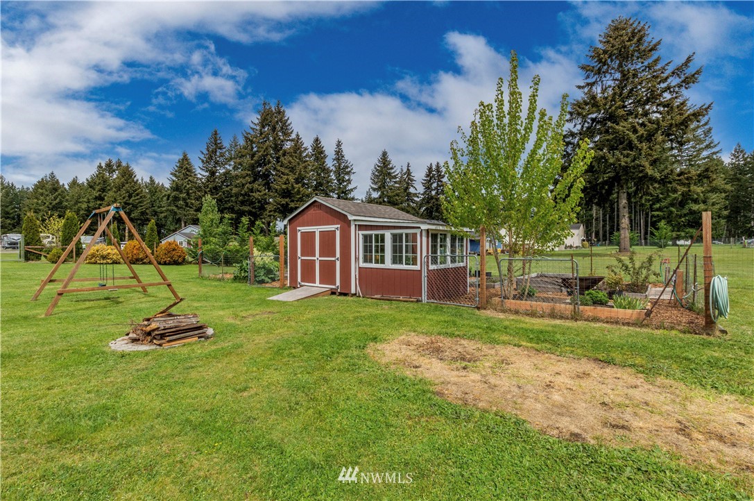 6519 190th Trail Southwest Rochester, WA 98579 - Photo 36 of 40 a front view of a house with a yard