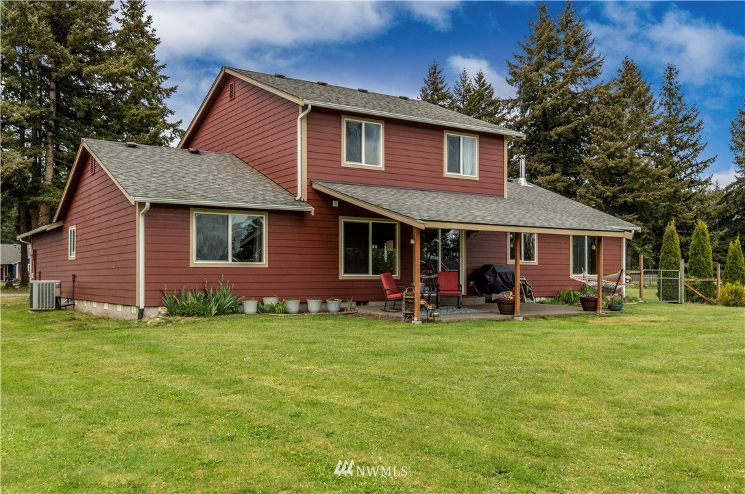 6519 190th Trail Southwest Rochester, WA 98579 - Photo 40 of 40 a front view of a house with a garden and trees