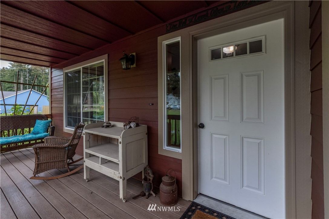 6519 190th Trail Southwest Rochester, WA 98579 - Photo 7 of 40 a balcony with furniture and a potted plant