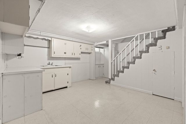 a utility room with cabinets washer and dryer