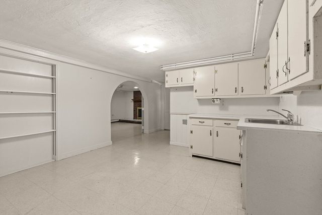 a kitchen with cabinets appliances a sink and a window