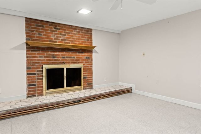 a view of an empty room with a fireplace