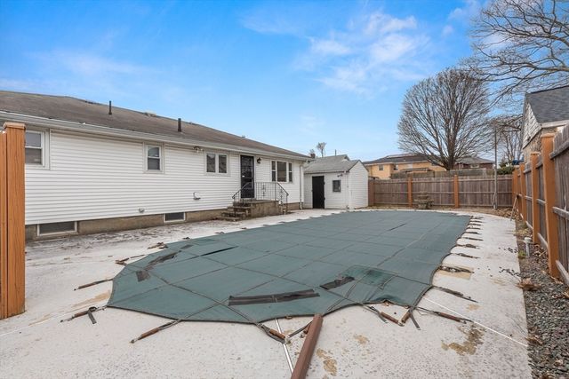a view of a white house with a large tree