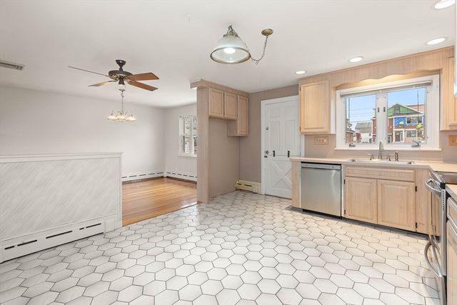 a kitchen with a stove a sink and a refrigerator
