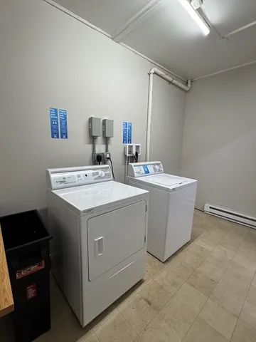 a view of a hallway with bathroom and wooden floor