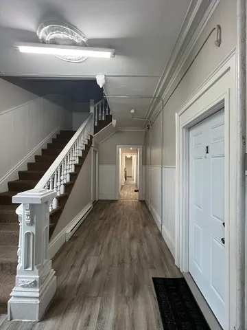 a kitchen with stainless steel appliances a refrigerator sink and wooden floor