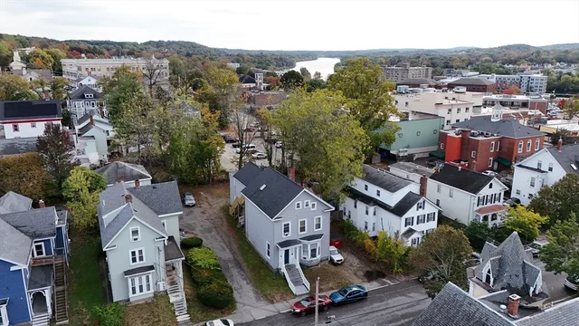 an aerial view of multiple houses with a city street