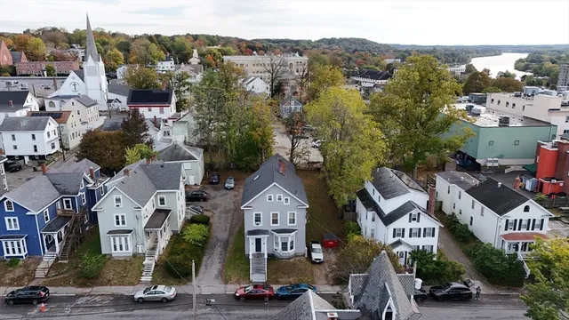 an aerial view of a house with a yard