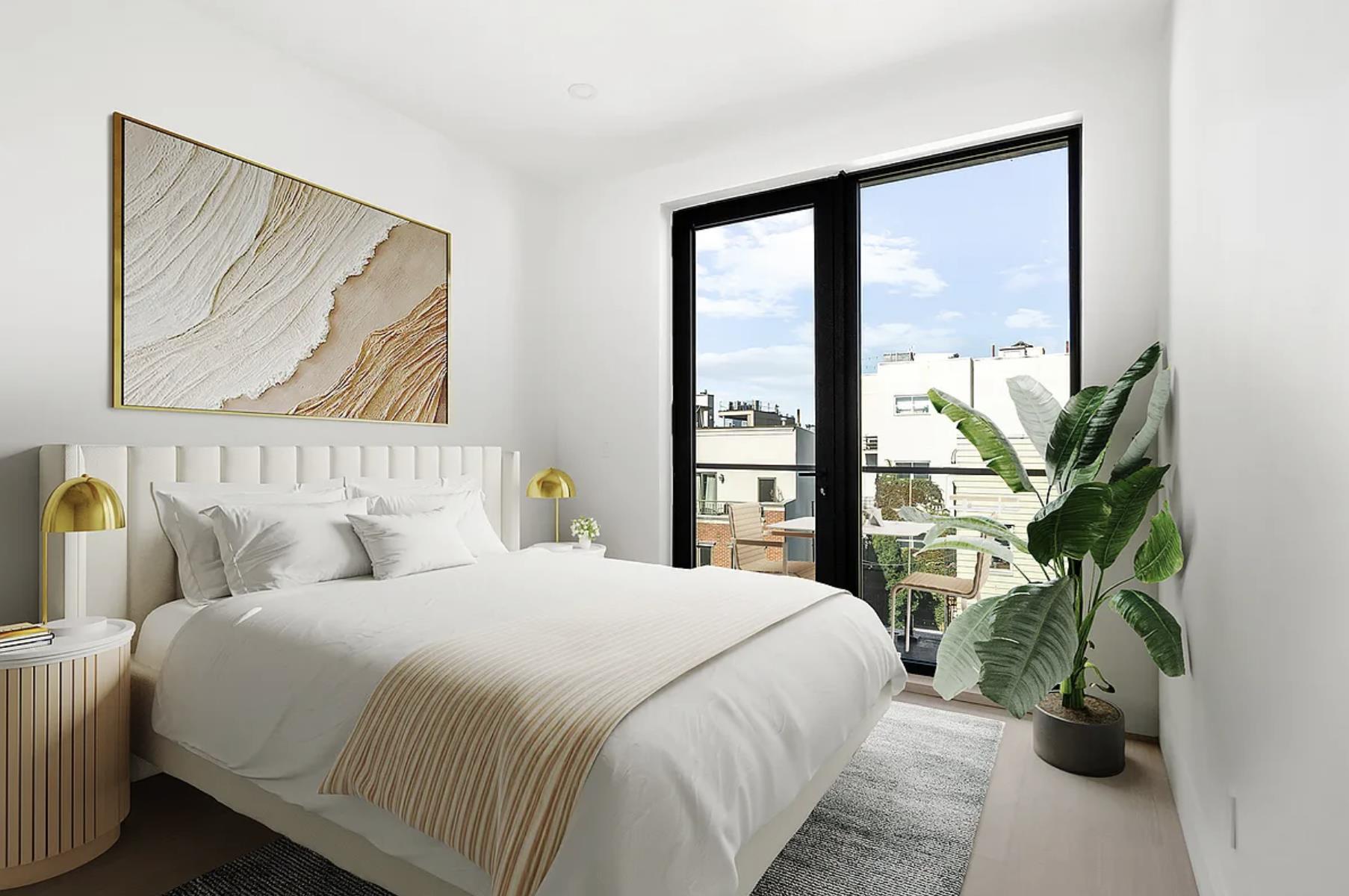 204 Withers Street, Unit 3A Brooklyn, NY 11211 - Photo 7 of 13 a bedroom with a large bed and a large window with potted plants