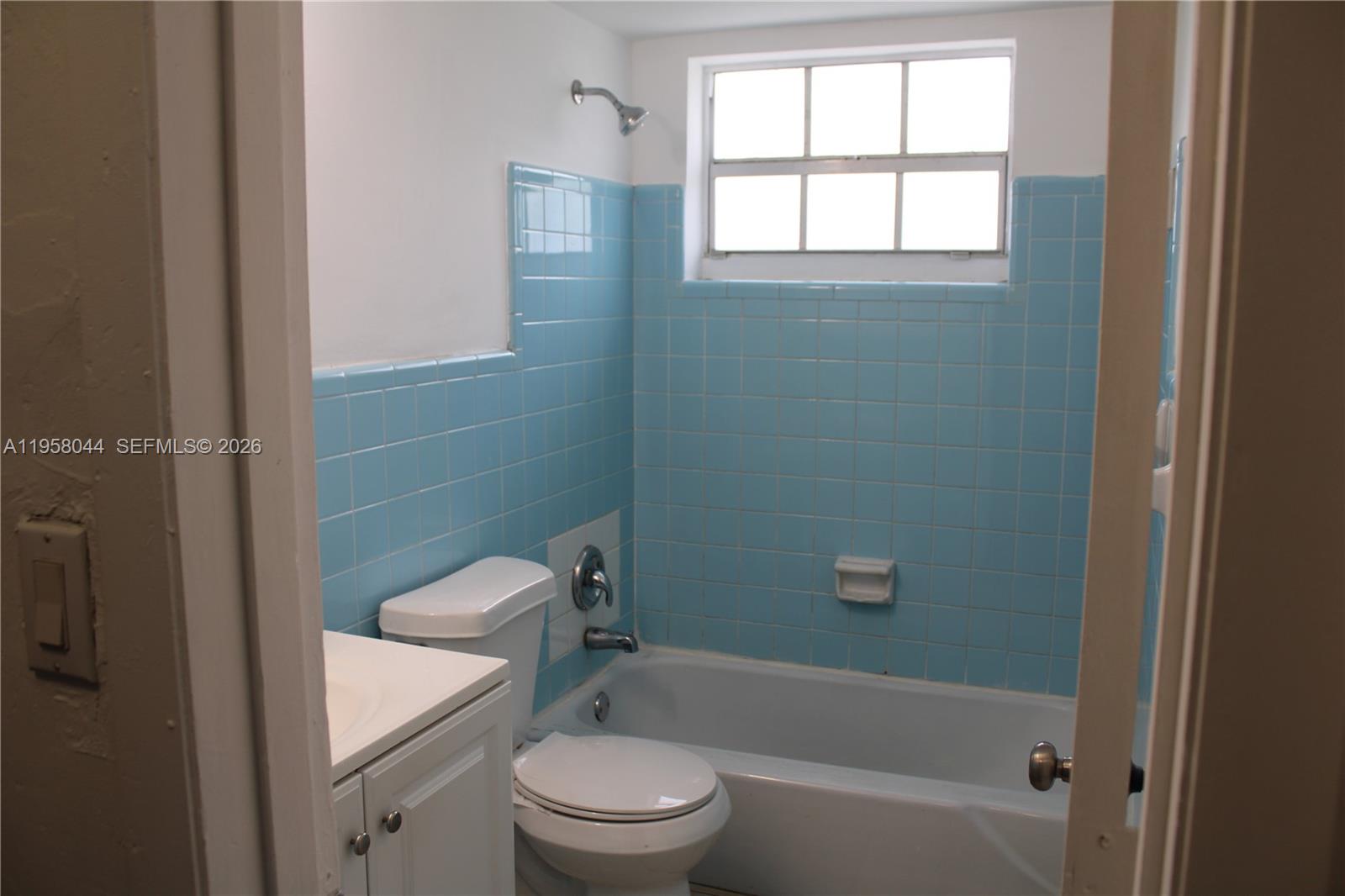 1601 Northwest 81st Street, Unit 1601 Miami, FL 33147 - Photo 11 of 13 a bathroom with a toilet a sink and bathtub