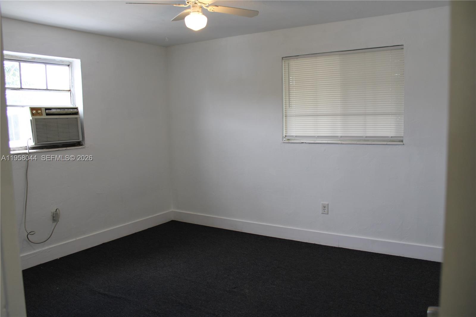 1601 Northwest 81st Street, Unit 1601 Miami, FL 33147 - Photo 8 of 13 an empty room with a window