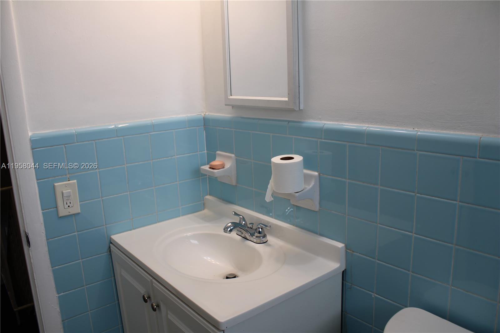 1601 Northwest 81st Street, Unit 1601 Miami, FL 33147 - Photo 10 of 13 a bathroom with a sink and vanity