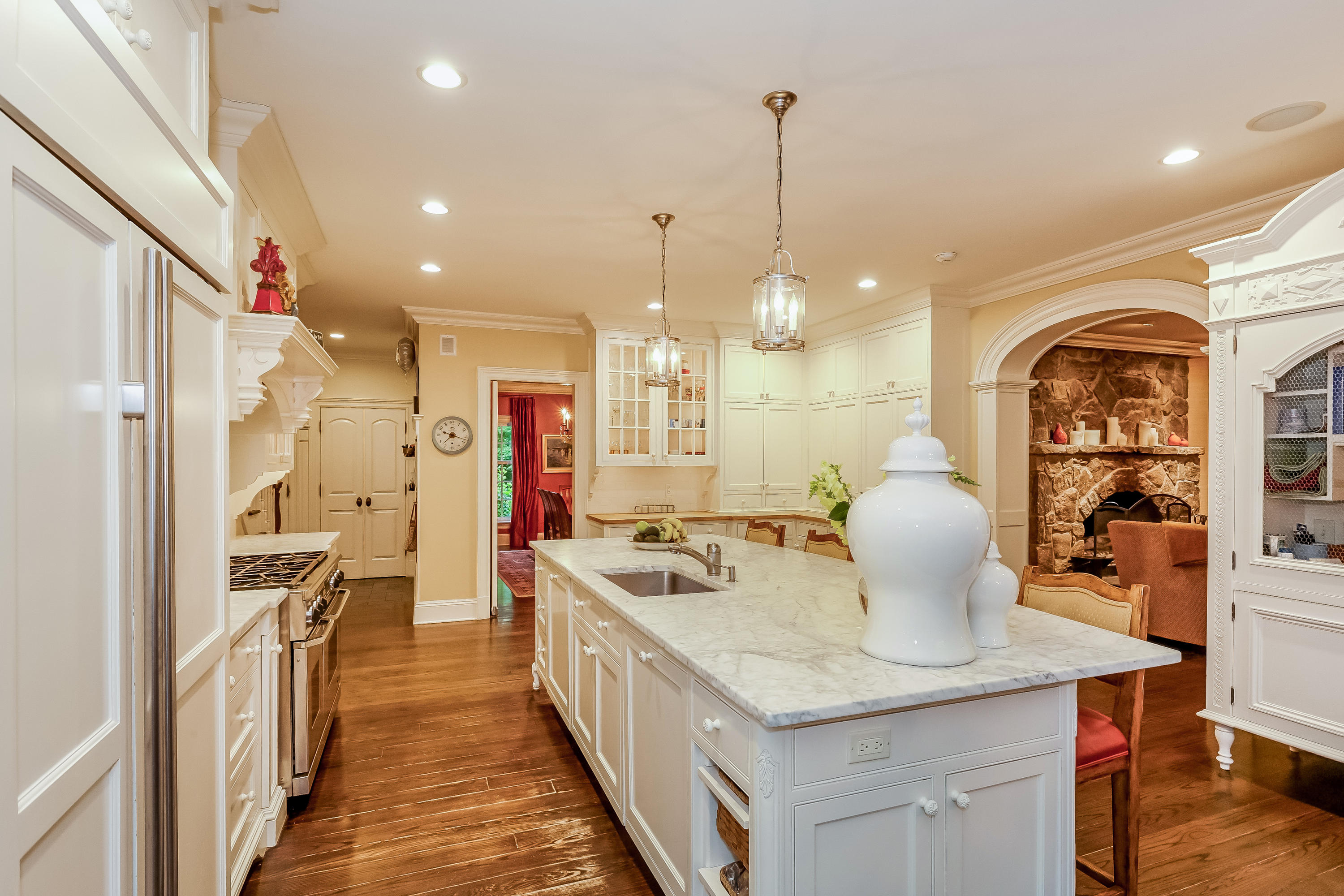 741 Hollow Tree Ridge Road Darien, CT 06820 - Photo 26 of 60 a open kitchen with stainless steel appliances kitchen island granite countertop a table chairs in it and wooden floors