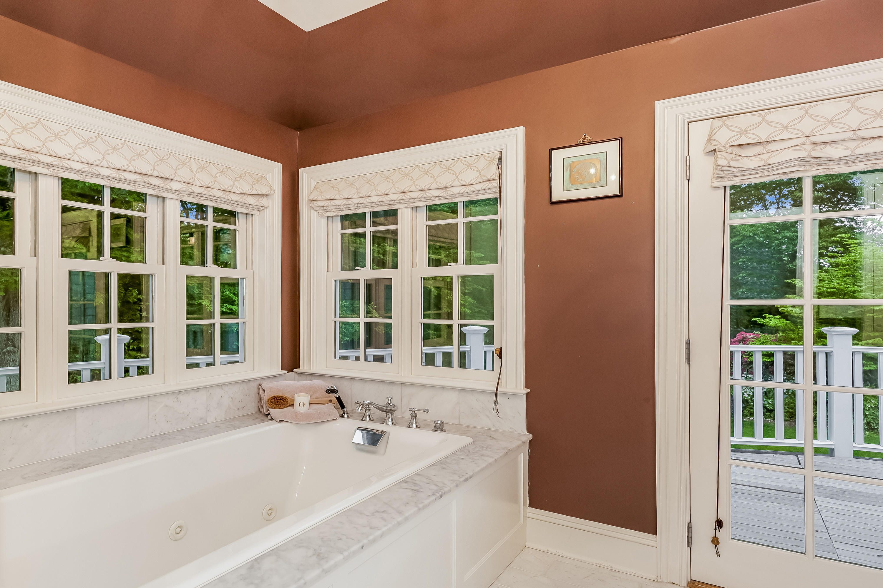 741 Hollow Tree Ridge Road Darien, CT 06820 - Photo 33 of 60 a bathroom with a bathtub and windows