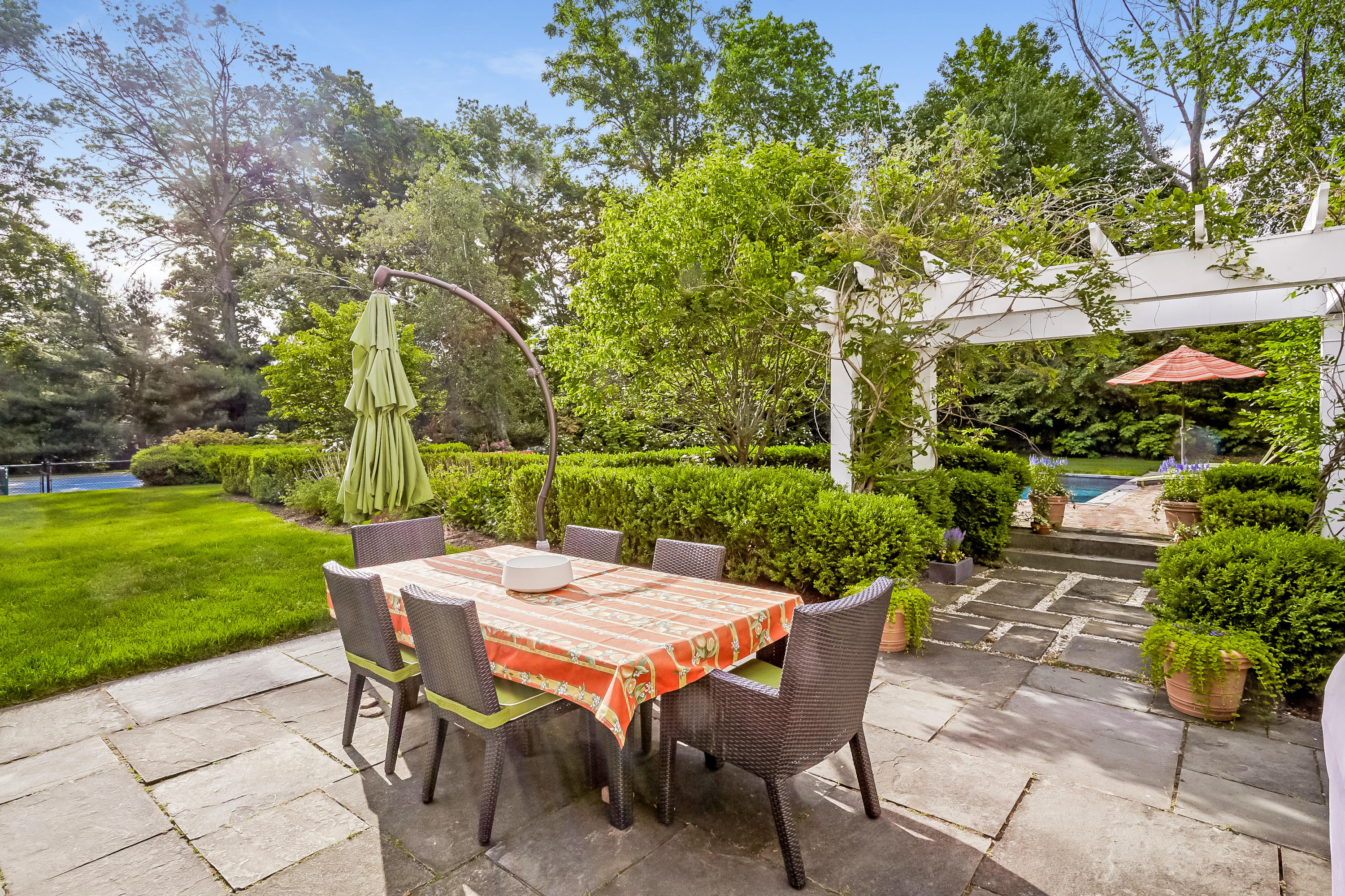 741 Hollow Tree Ridge Road Darien, CT 06820 - Photo 44 of 60 a view of a patio with a table and chairs