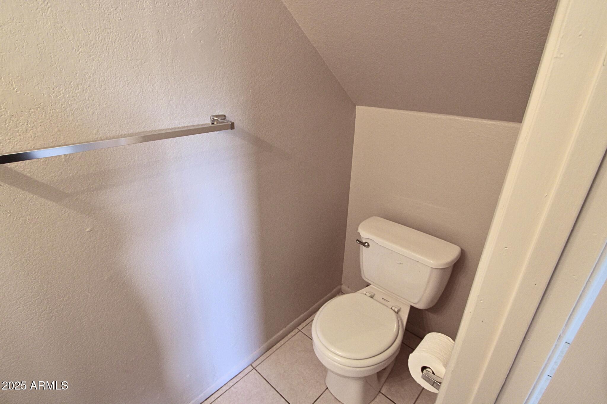 410 East 9th Avenue, Unit 1 Mesa, AZ 85204 - Photo 11 of 17 a white toilet sitting next to a shower