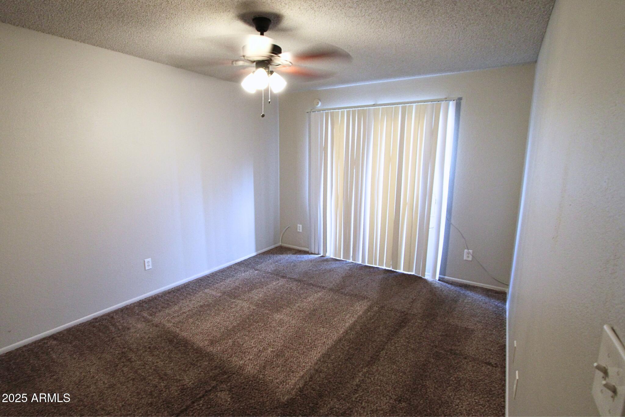 410 East 9th Avenue, Unit 1 Mesa, AZ 85204 - Photo 13 of 17 an empty room with windows and fan